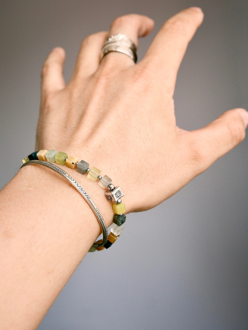 Stacked men’s bracelets with Xiuyu jade and silver feather bracelet, natural stone layering style