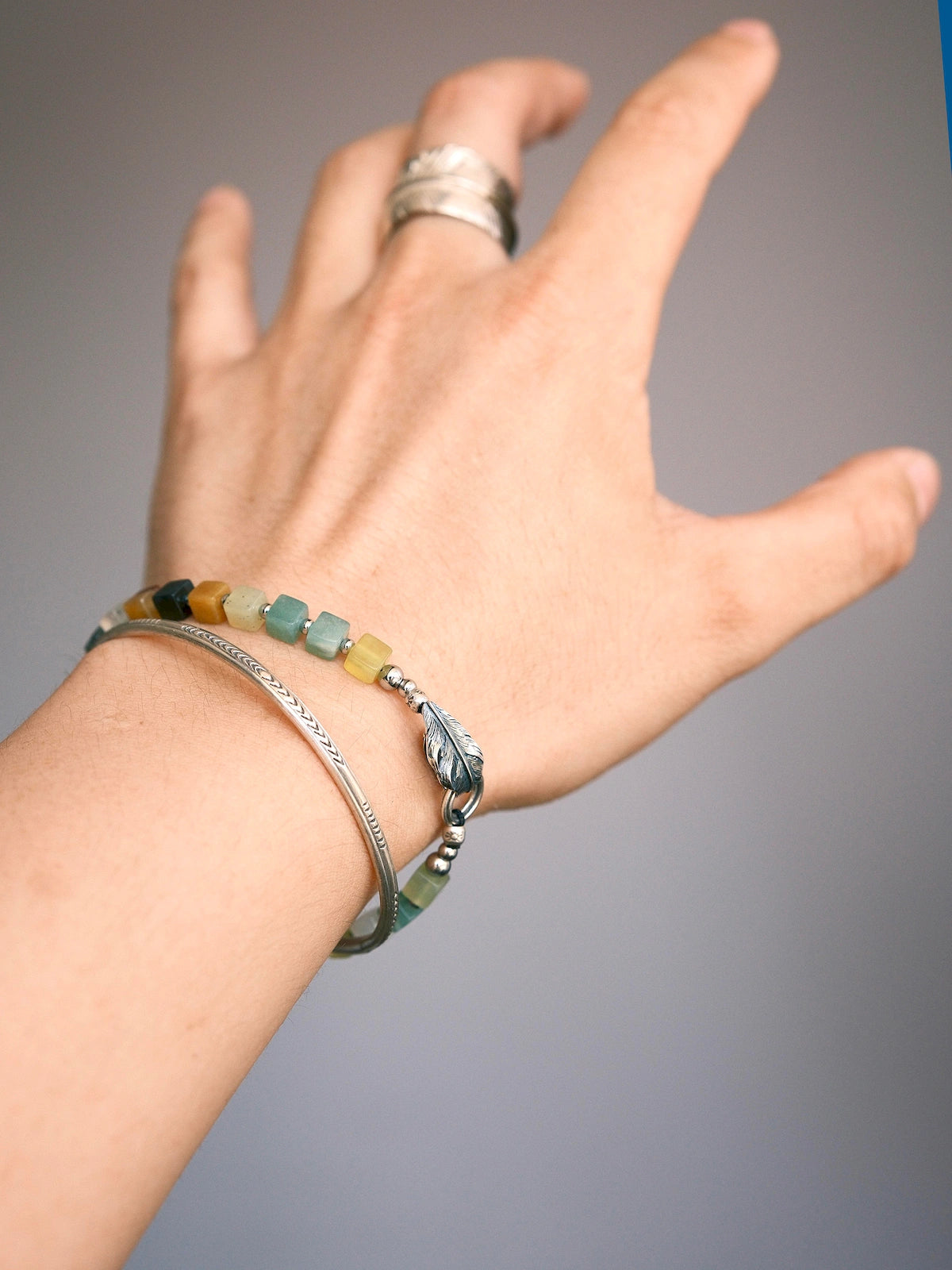 Weekend casual men’s jade bracelet, earth tone Xiuyu jade beads, silver feather charm, relaxed styling