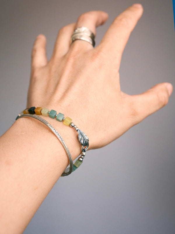 Weekend casual men’s jade bracelet, earth tone Xiuyu jade beads, silver feather charm, relaxed styling