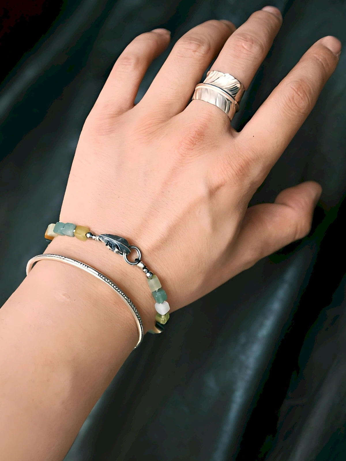 Stacked men’s bracelets with Xiuyu jade and silver feather bracelet, natural stone layering style