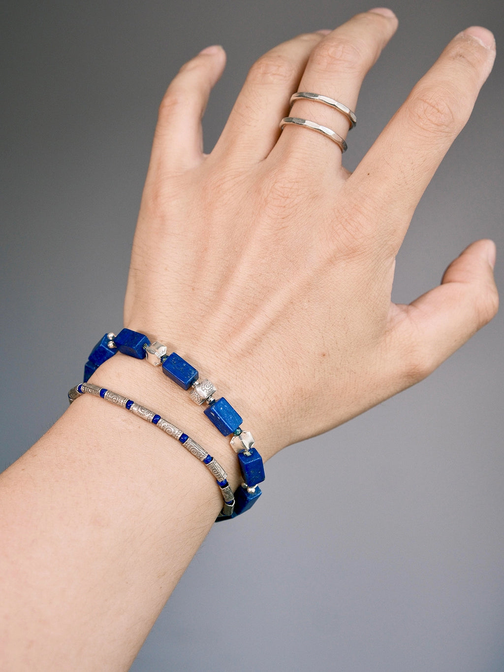 Lapis lazuli and 990 fine silver bracelet stacked with a slim silver bracelet for a refined layered wrist look.