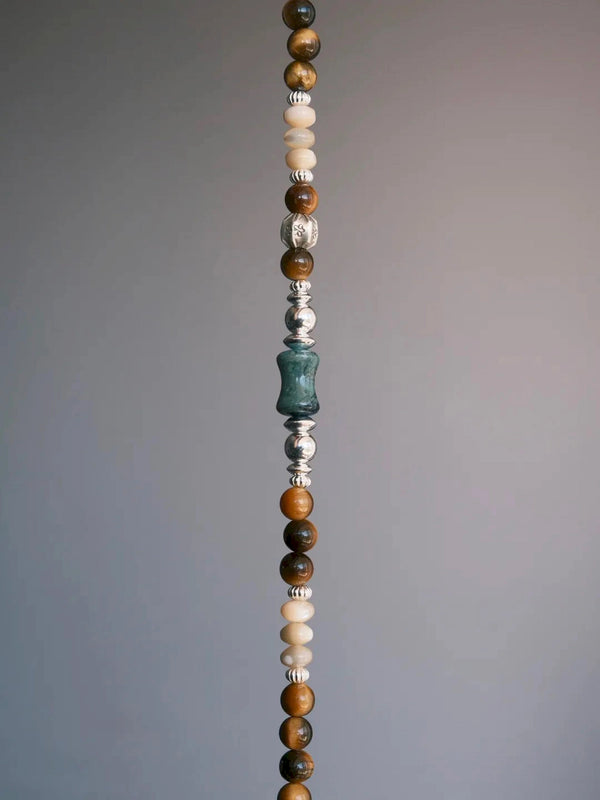 Vertical product view of the Ochre Monarch bracelet highlighting tiger eye, mother-of-pearl, green agate and sterling silver details