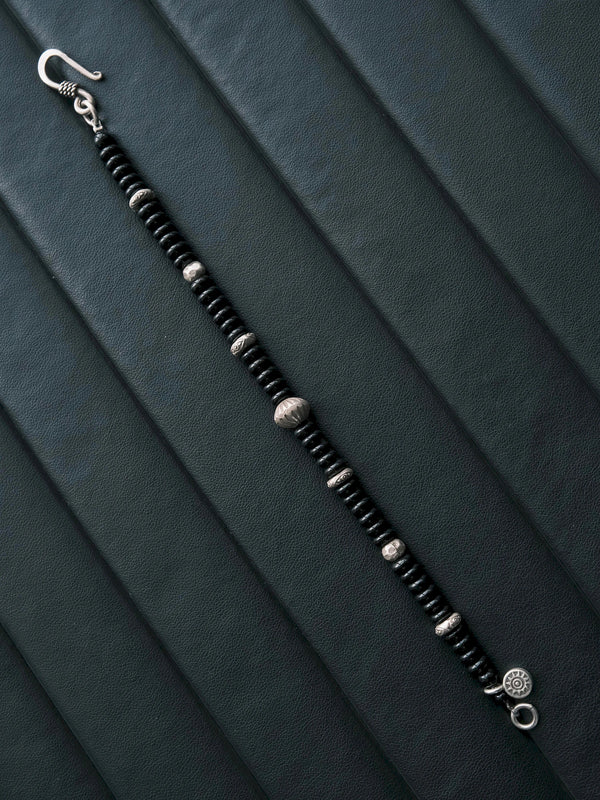 Monochrome menswear mood image featuring the Dawn Sentinel black onyx and silver bracelet