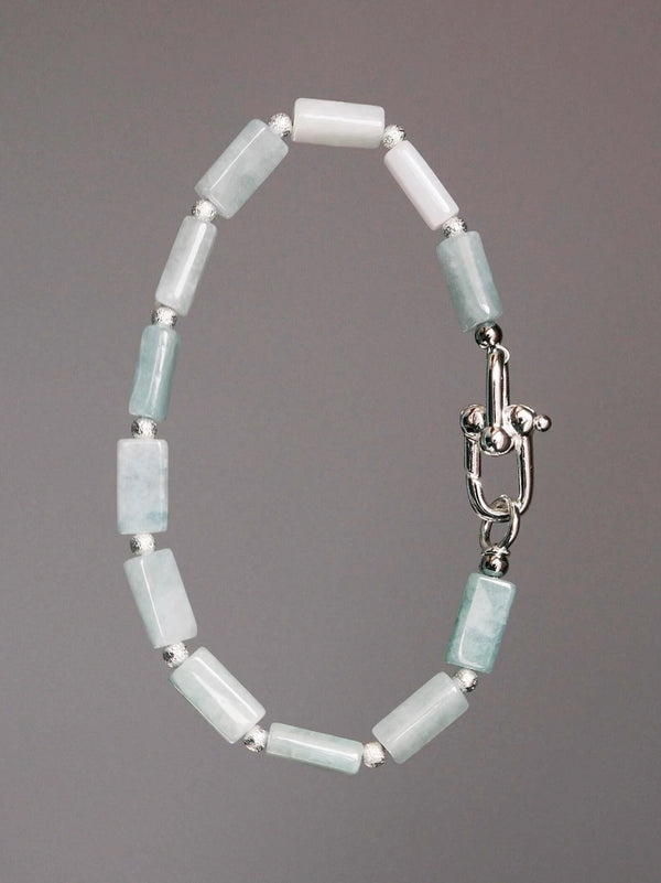 Black and white mood image with men’s jade bracelet, quiet masculine energy and cold aesthetic style